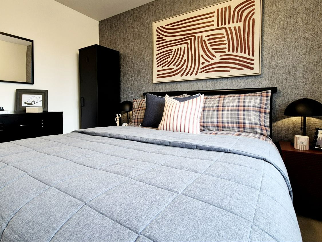 masculine show home bedroom in blues blacks and reds